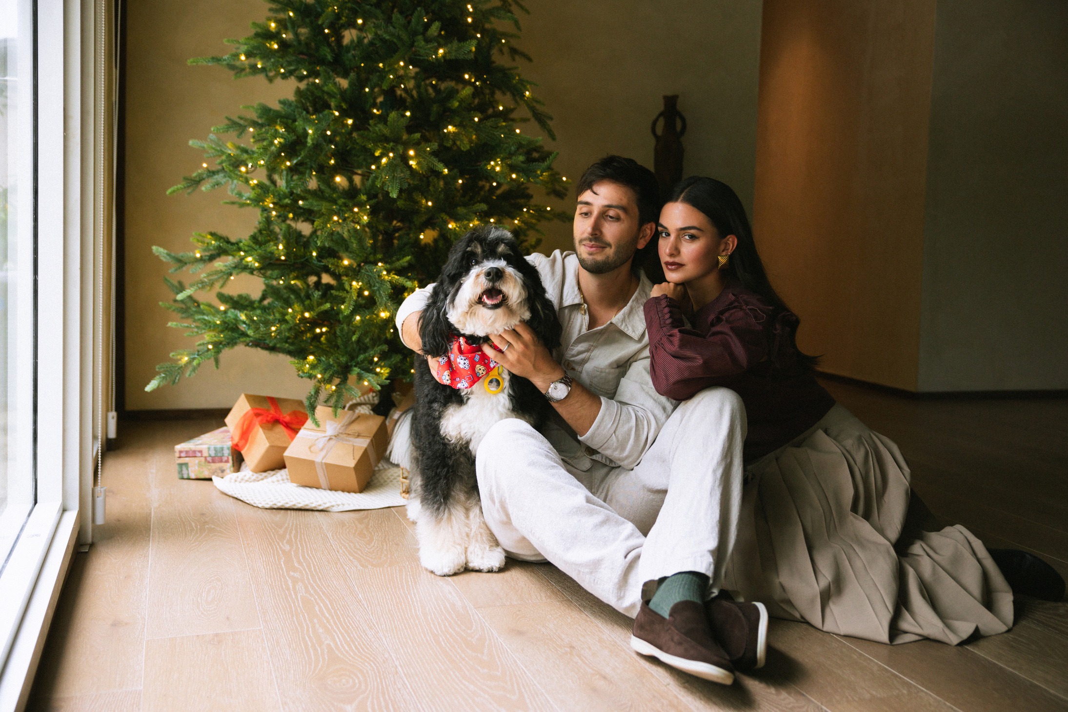 Una pareja y su perro junto al árbol